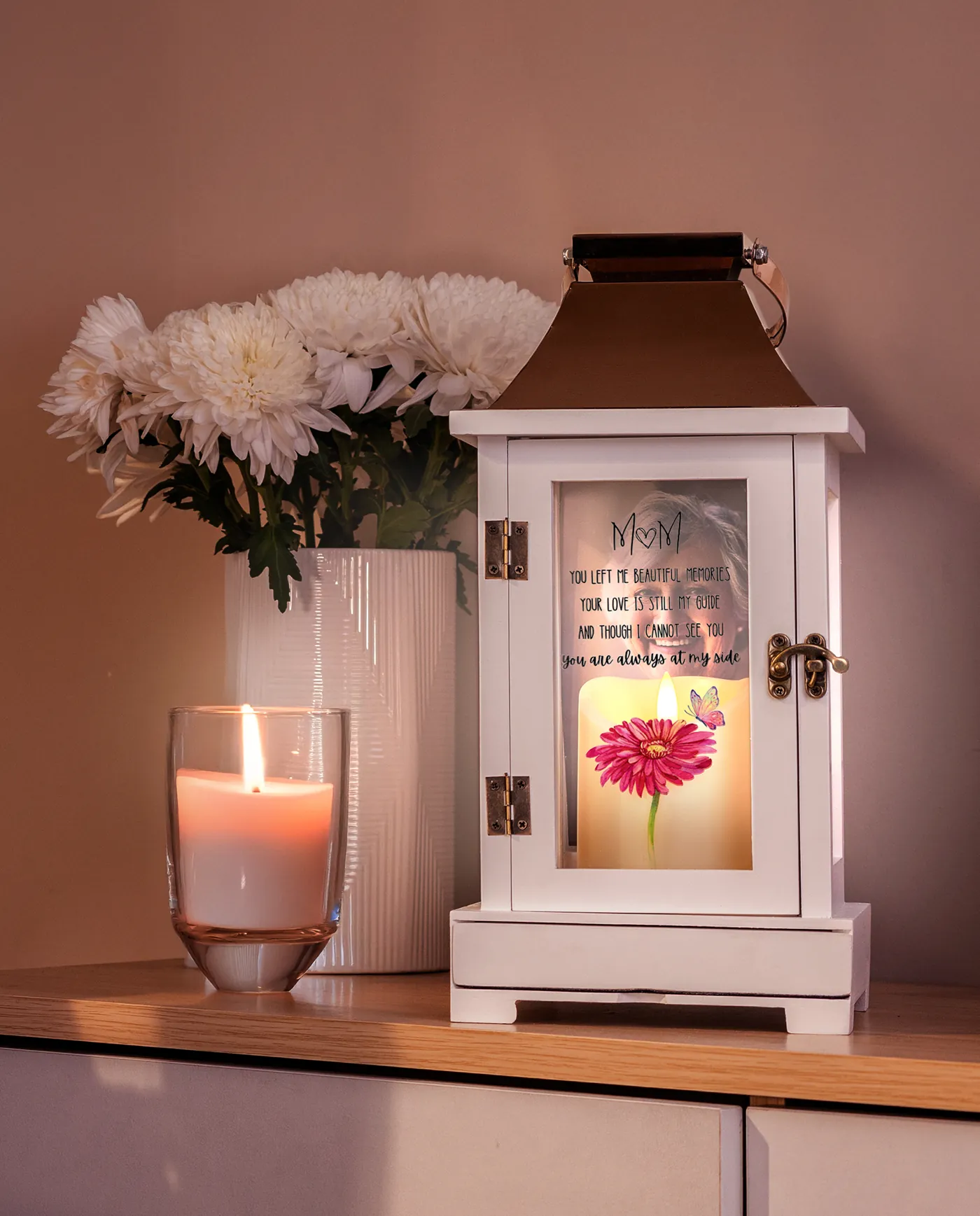 The wood lantern with a copper crown, lit beside white flowers
